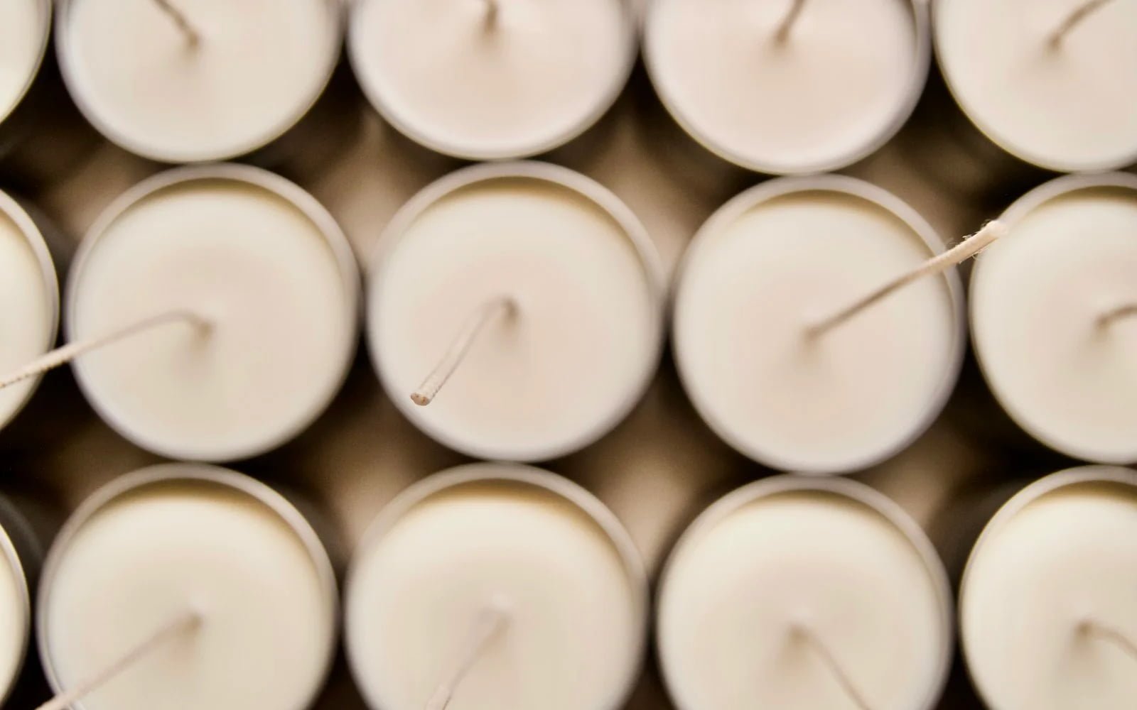Rows of white candles for candle mold visual demo